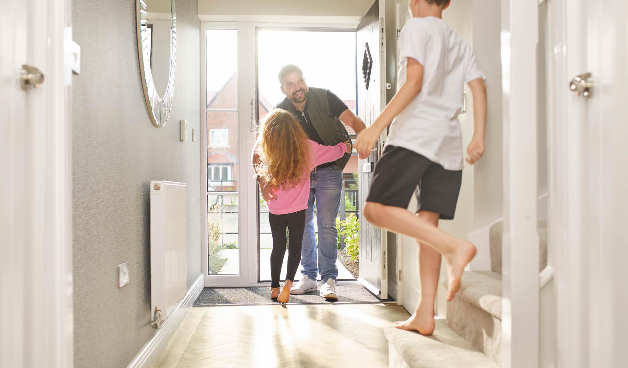 Man being greeted at the door